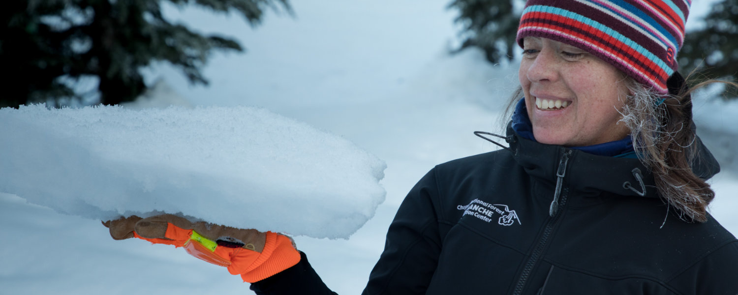 Chugach National Forest Avalanche Information Center Forecaster holding a slab of snow topped with surface facets